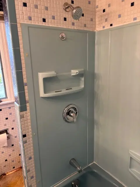 Bathroom shower and tub area featuring new shower fixtures, wall-mounted soap dish, and modern tile design, illustrating renovation improvements by Next Step Property Services LLC.